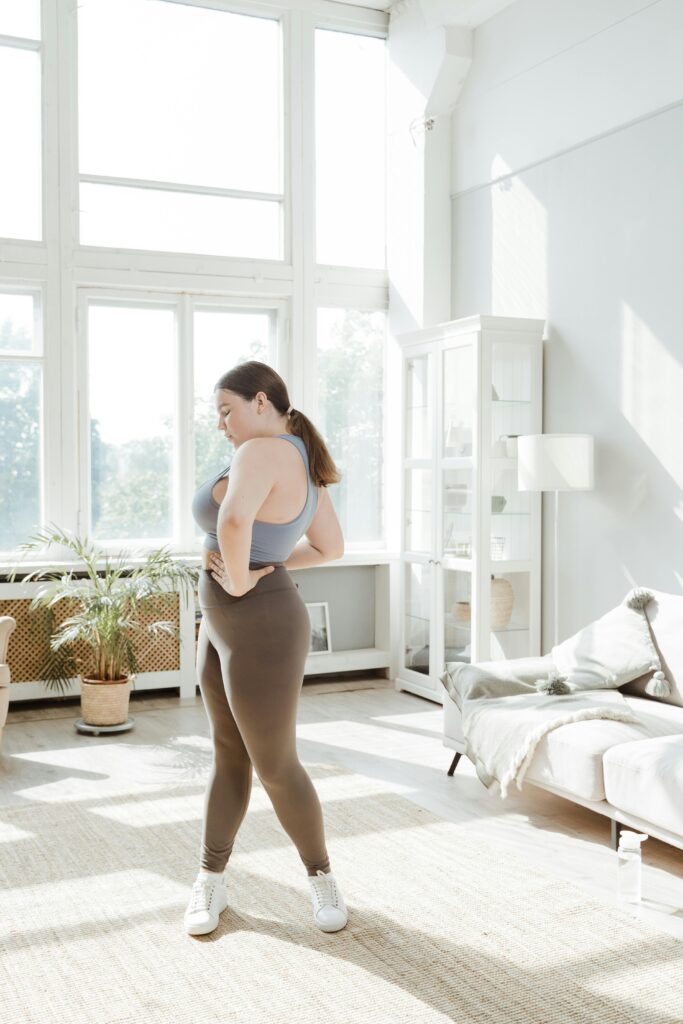 pexels-photo-8846440-8846440 Confident plus size woman practicing yoga in a bright, serene living room.